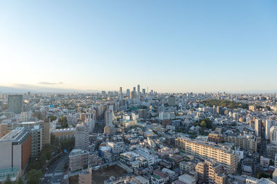 High angle view of city buildings against clear sky