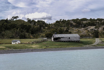 Scenic view of lake by building against sky