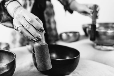 Woman playing tibetan singing bowl in sound healing therapy