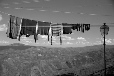 Clothes drying on rope against sky