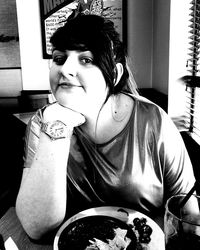 Portrait of woman sitting at home