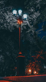 Low angle view of illuminated street light at night