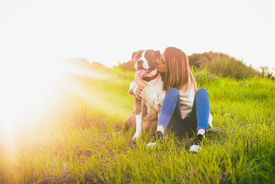 Woman with dog on field