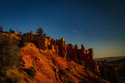 Low angle view of rock formations at night