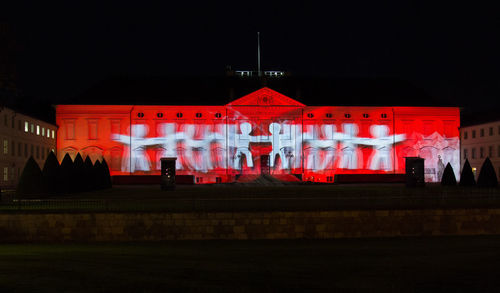 Red illuminated building at night