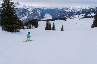 Full length of man skiing on snowcapped mountain