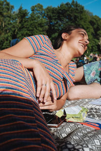 Happy woman sitting on a tree