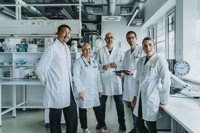 Confident scientist team standing together at laboratory