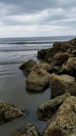 Scenic view of sea against cloudy sky