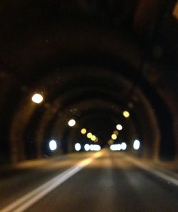 Illuminated tunnel at night