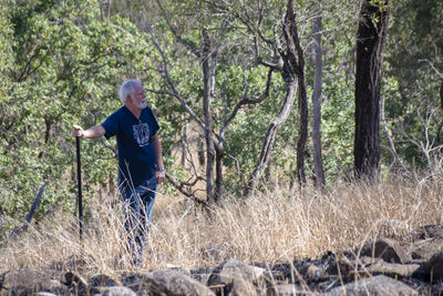 Full length of man standing in forest