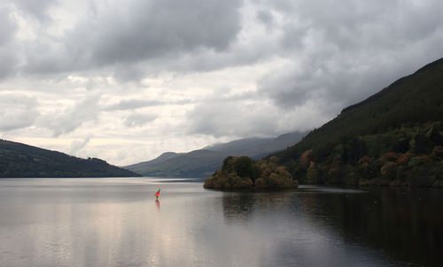 Scenic view of lake against cloudy sky