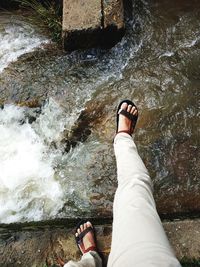 Low section of person legs in water