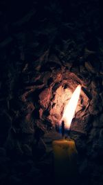 Close-up of lit candles on rock