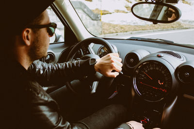 Close-up of man sitting in car