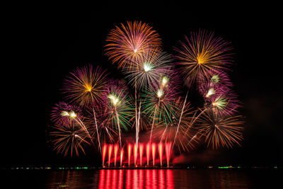 Low angle view of firework display at night