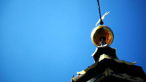 Low angle view of statue against clear blue sky
