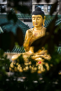 Statue of buddha against blurred background