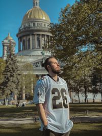 View of young man standing against building