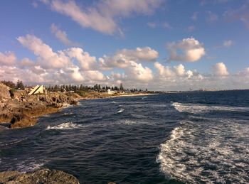 View of beach against cloudy sky