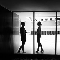 Full length of woman standing by railing