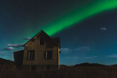 Built structure on field against sky at night