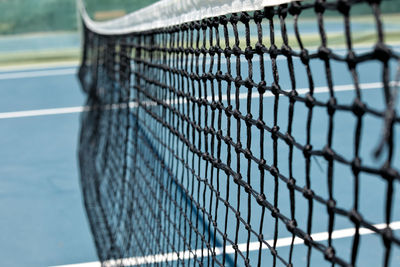 Close-up of tennis net in court