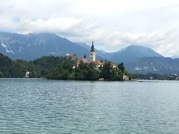 Scenic view of lake by mountains against sky