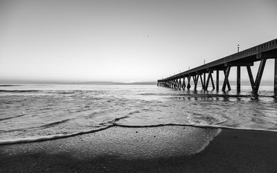 View of bridge over sea against clear sky