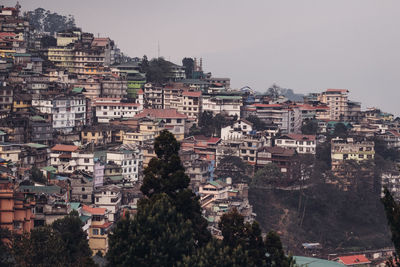 Buildings in city against clear sky