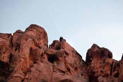 Low angle view of rock formations against sky