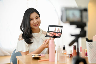 Portrait of young woman using mobile phone