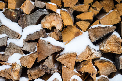 Full frame shot of logs with snow during winter