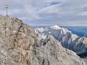 Scenic view of mountains against cloudy sky