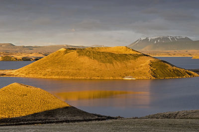 One of the pseudocraters at the edge of lake myvatn, illuminated by the sun in the golden hour