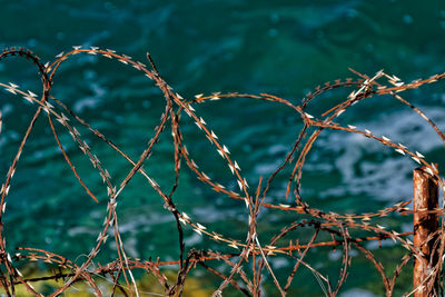 High angle view of barbed wires over sea