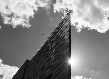 Low angle view of modern building against sky on sunny day