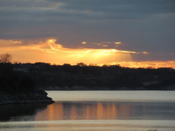 Scenic view of lake against sky during sunset