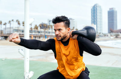 Portrait of young man exercising in gym