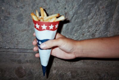 Close-up of hand holding ice cream cone