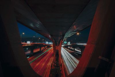 Illuminated light trails on road in city at night