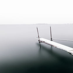 Scenic view of foggy weather against sky