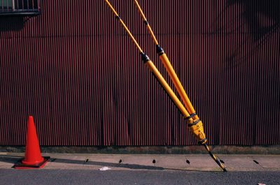 Fire hydrant on road against wall in city