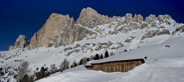 Snowcapped mountains against clear sky during winter