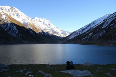 Scenic view of frozen lake against clear blue sky