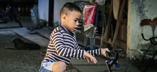 Side view of boy riding bicycle