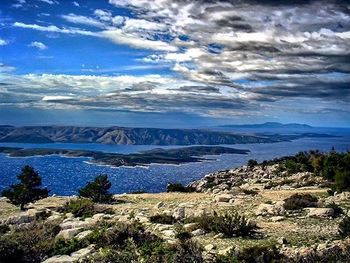 Scenic view of lake against cloudy sky