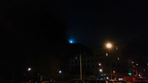 Vehicles on illuminated street at night