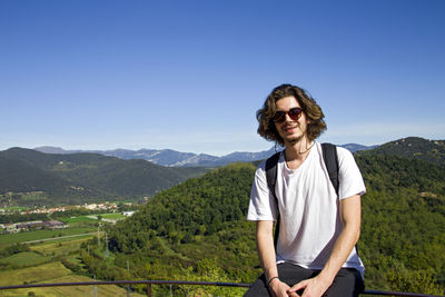 Portrait of smiling male hiker during sunny day