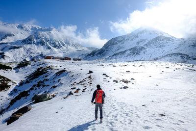 The man walks through the snow mountain.